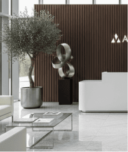 Modern luxury building lobby with an olive tree, sculpture and reception desk